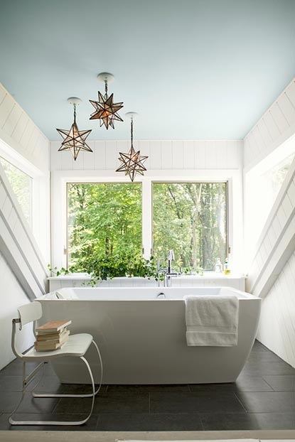 Bathroom with a soft blue ceiling and white modern bathtub. Bathroom with a soft blue ceiling and white modern bathtub.