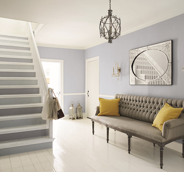 Light blue-gray and white entryway with classic furniture accents. Light blue-gray and white entryway with classic furniture accents.