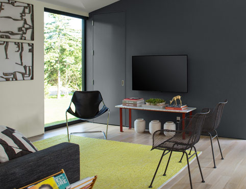 Gray painted accent wall with white walls in living room. Gray painted accent wall with white walls in living room.