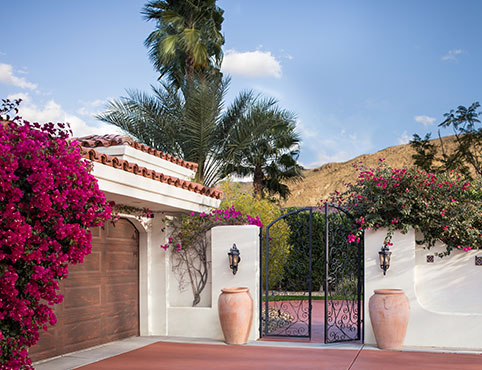 Gated driveway on a southwestern style home overlooking a scenic mountain range. Gated driveway on a southwestern style home overlooking a scenic mountain range.