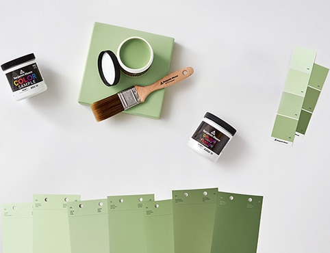 An open can of paint color sample and an array of color swatches. An open can of paint color sample and an array of color swatches.